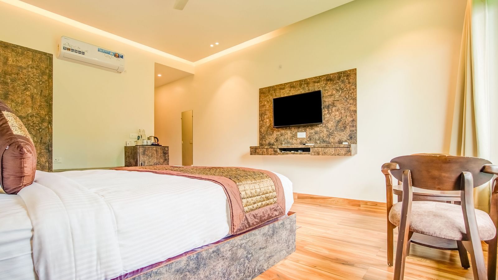 An image of a bedroom which also has a flat TV sceen and a chair - Summit Jungle Resort, Lansdowne