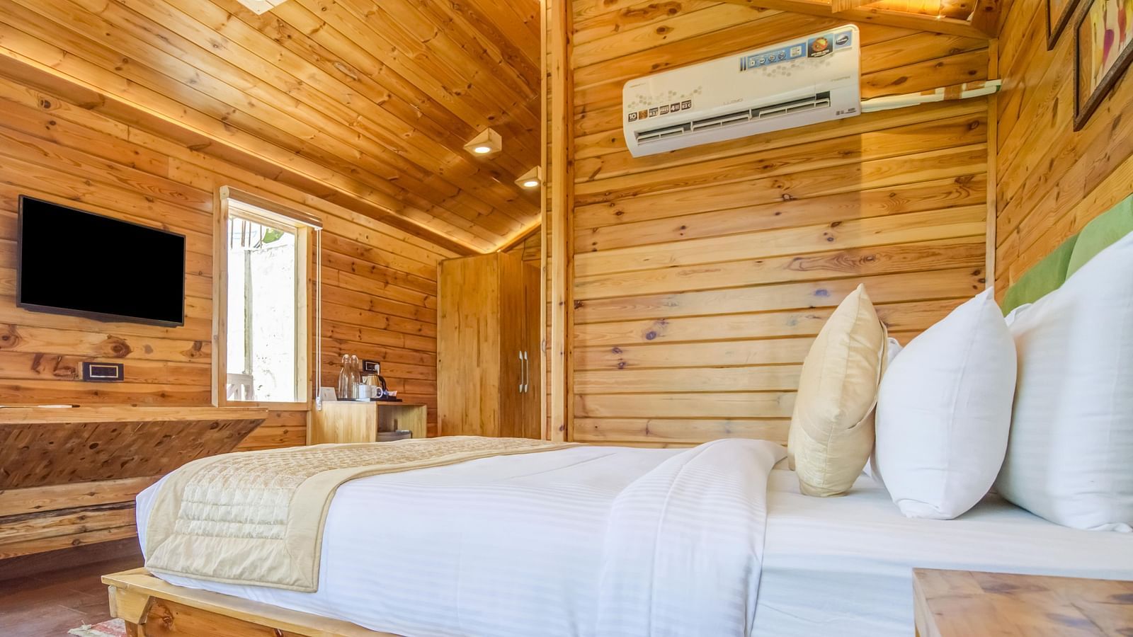 An image of a wooden bedroom which also has a flat screen TV and a window - Summit Jungle Resort, Lansdowne