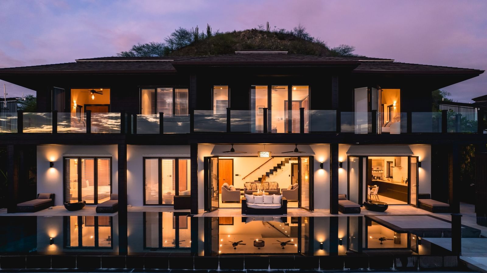 A facade image of a resort captured at dusk.