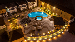 An aerial view of the swimming pool at night - Shyama Sarovar Portico Orai