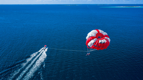 a person parasailing in pristine waters