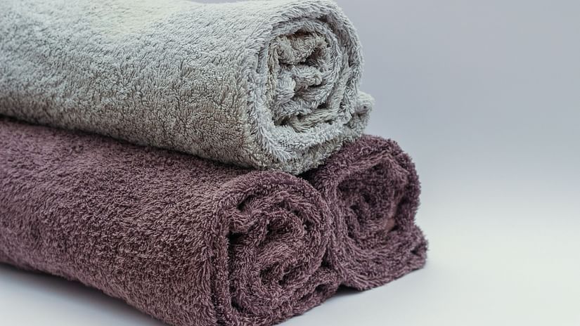 Three towels neatly rolled and stacked up