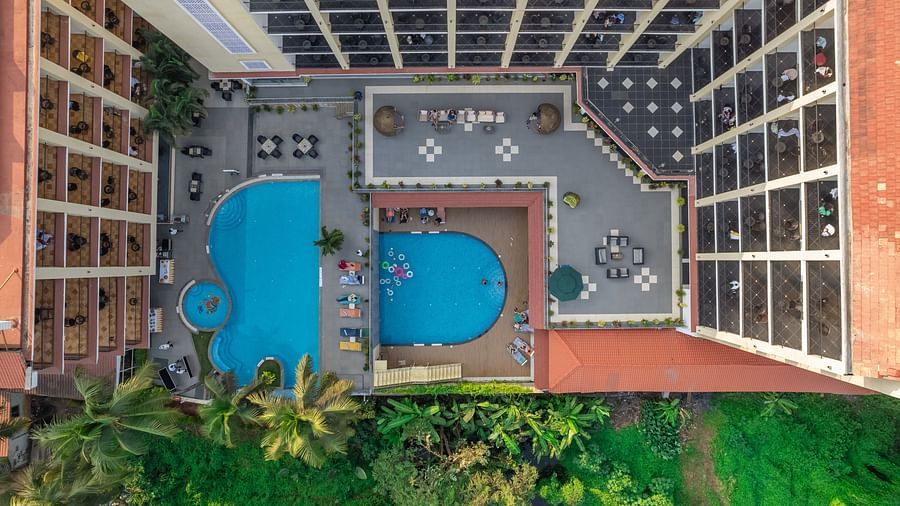 Full top-down shot of the Golden Tulip, Candolim, Goa's building and its pool area.
