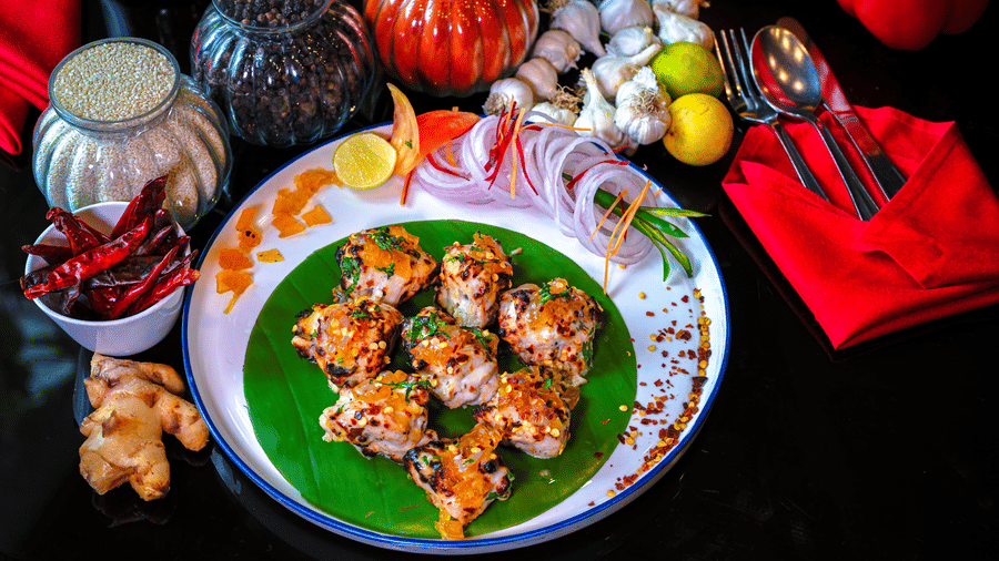 A special dish served on a plate with spice bottles placed in the backdrop for decoration at Clarks Hotels.