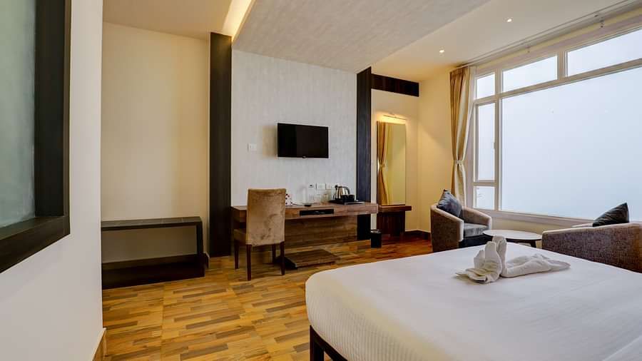 view of king size bed and TV of a Deluxe Room Banari Regency by Summit, Namchi