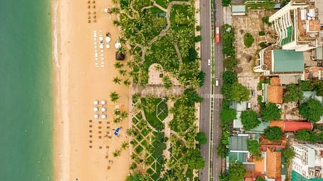 An aerial view of Nha Trang with the beach, sea, nature, road and buildings in view