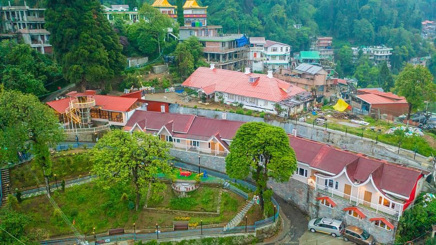 A far drone shot of the property and the entire resort with trees around-Arcadia Heritage Resort, Darjeeling.