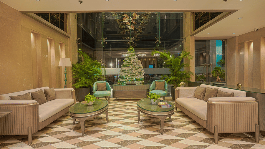 The hotel lobby with beige sofas, armchairs and a checkered floor-  BluSalzz