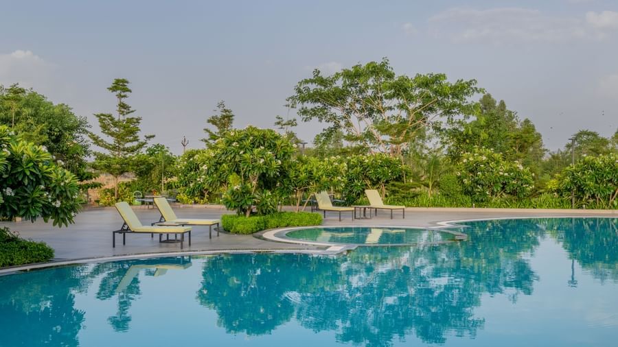 An open-air dining or lounge space beneath a contemporary pergola at Hotel Highway King Shahpura.
