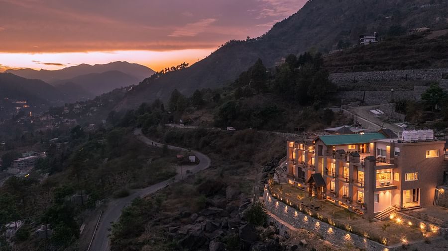 facade of the Leisure hotel with mountains in the background at sunset at Mountoria Retreat, Naukuchiatal