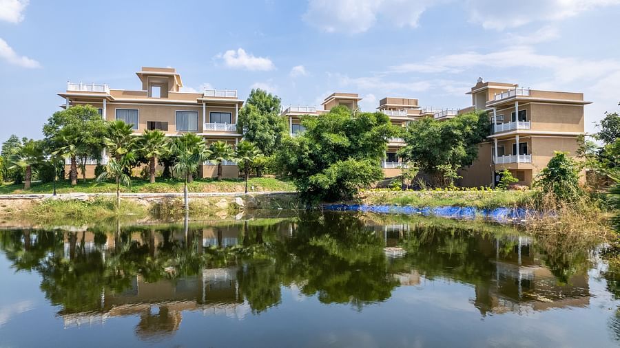 A tranquil reflection of the buildings on a pristine lake at our wellness centre - Rajbagh Wellness, Udaipur