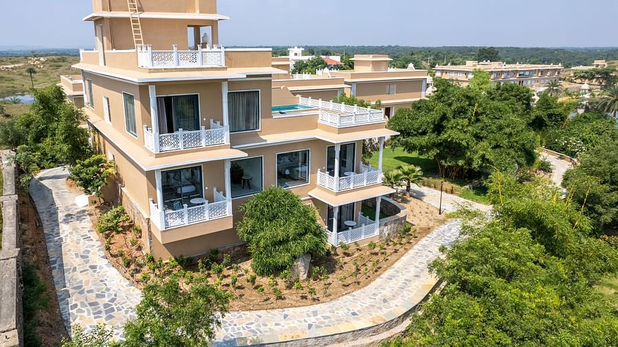 An aerial shot of a building surrounded by lush greenery - Rajbagh Wellness, Udaipur