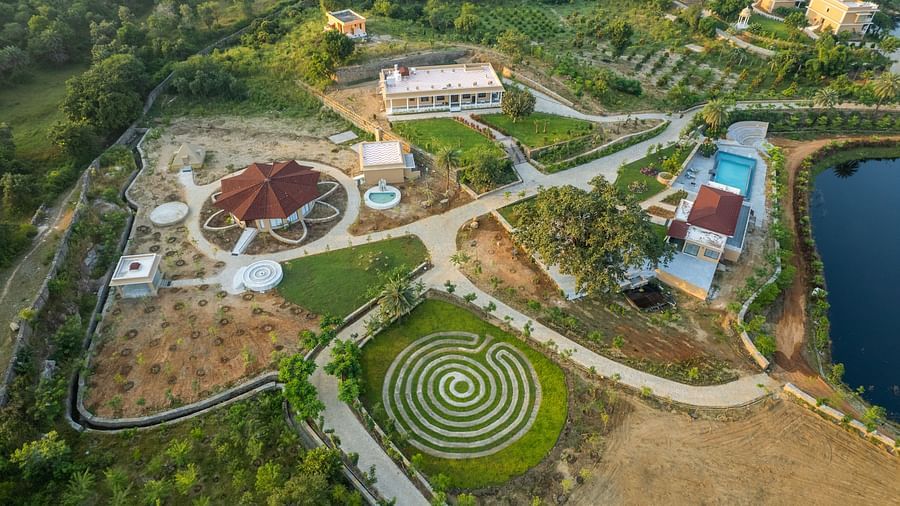 An aerial image of our wellness retreat situated near a water body - Rajbagh Wellness, Udaipur