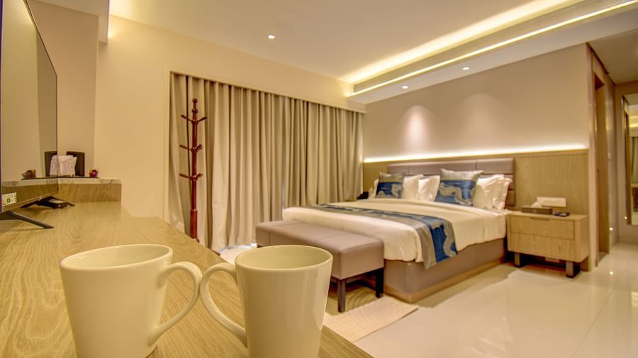 A hotel room with two beds, two mugs, and a view of the bathroom - The SSK Solitaire Boutique Hotel & Spa, Gangapur Road - Nashik