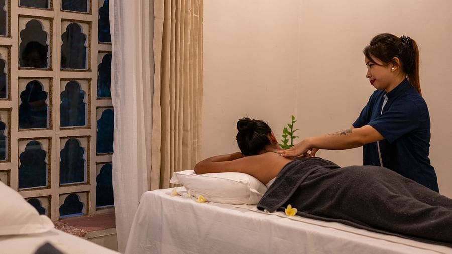 A masseuse providing a back massage - Utsav Camp