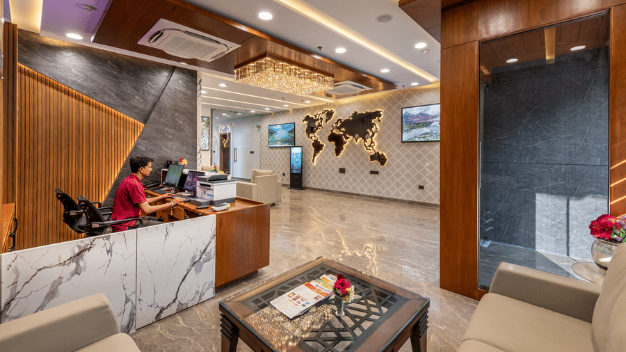 Modern Lords hotel lobby with a marble floor, cozy seating, and a reception desk with warm lighting.