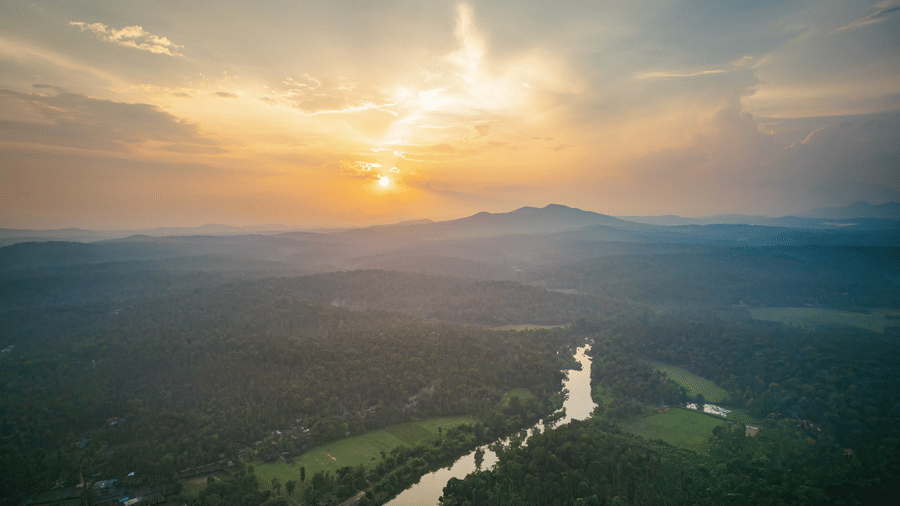 Aerial view of Coorg valley with river and greenery near Evolve Back resort