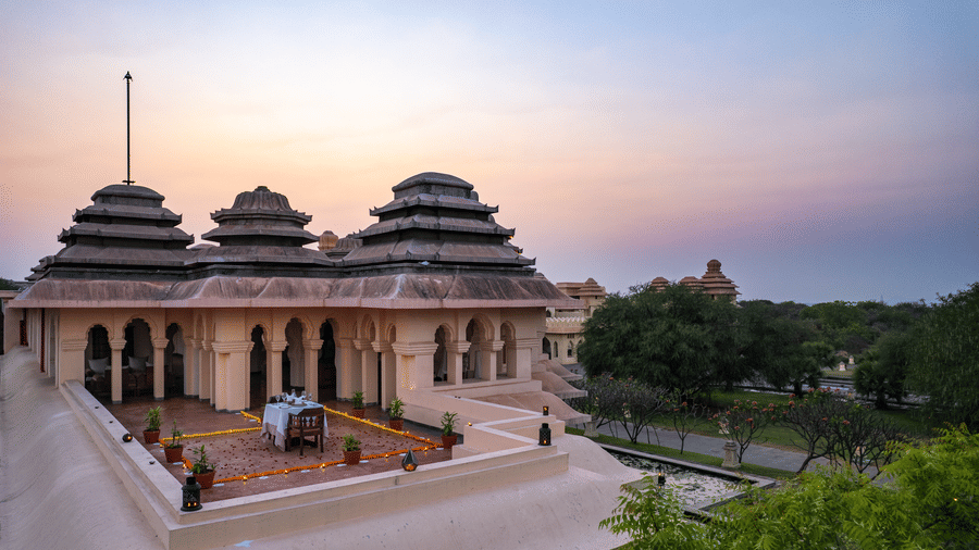 Stunning temple-style resort architecture at sunset at Evolve Back Hampi