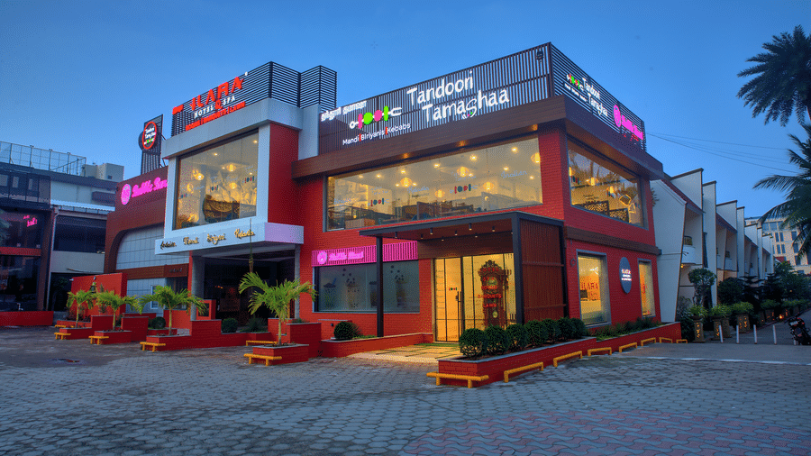 Exterior view of Tandoori Tamashaa building lit up in the evening at Ilara Hotels & Spa, OMR, Chennai