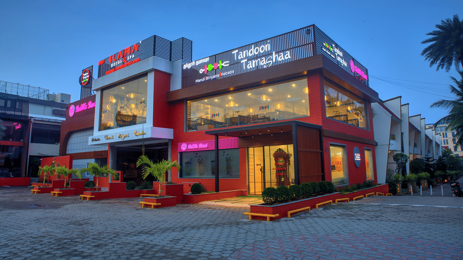 Exterior view of Tandoori Tamashaa building lit up in the evening at Ilara Hotels & Spa, OMR, Chennai