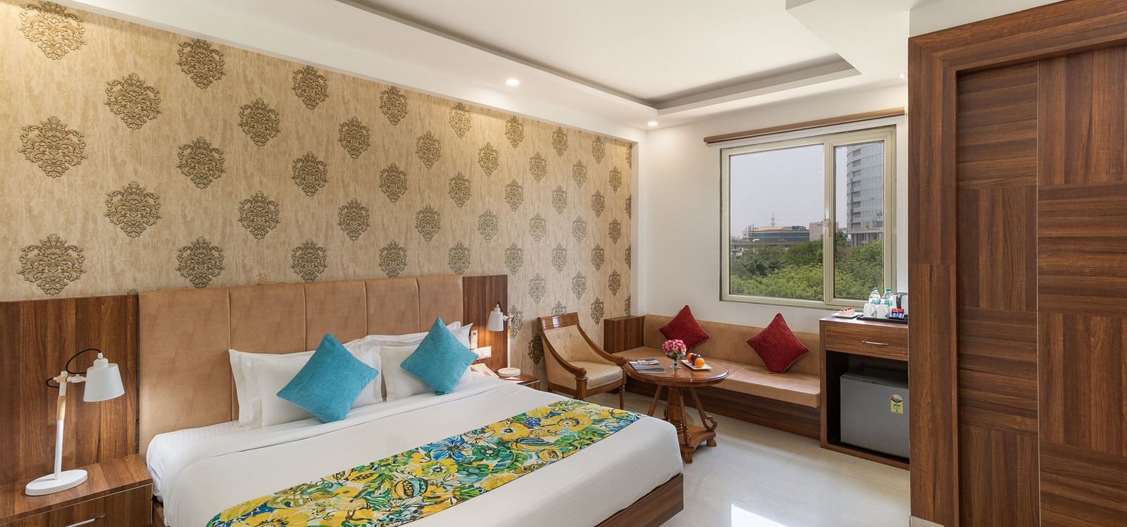 A spacious hotel room featuring a king size bed, comfortable seating, and modern amenities | Inde Hotel Cyber City 