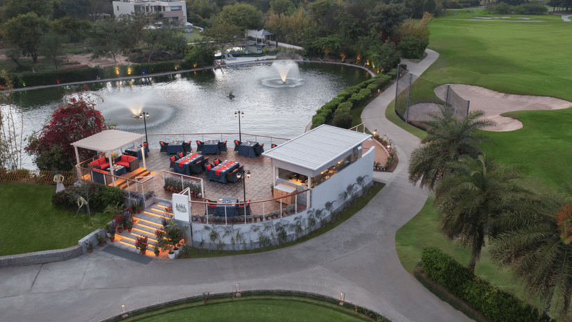 A building next the waterbody and golf course - Karma Lakelands.