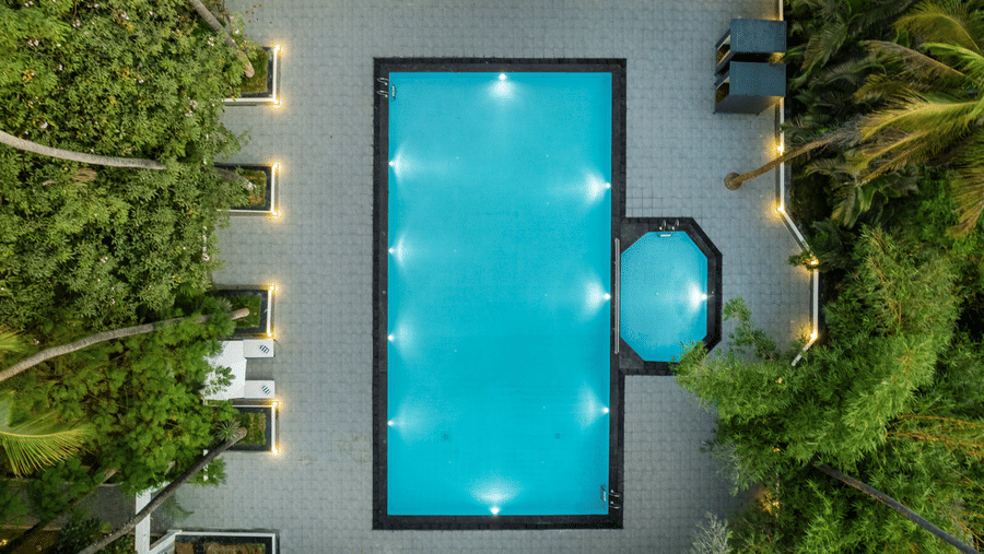 Aerial view of a swimming pool surrounded by greenery - Mango Hill Resort, Coimbatore