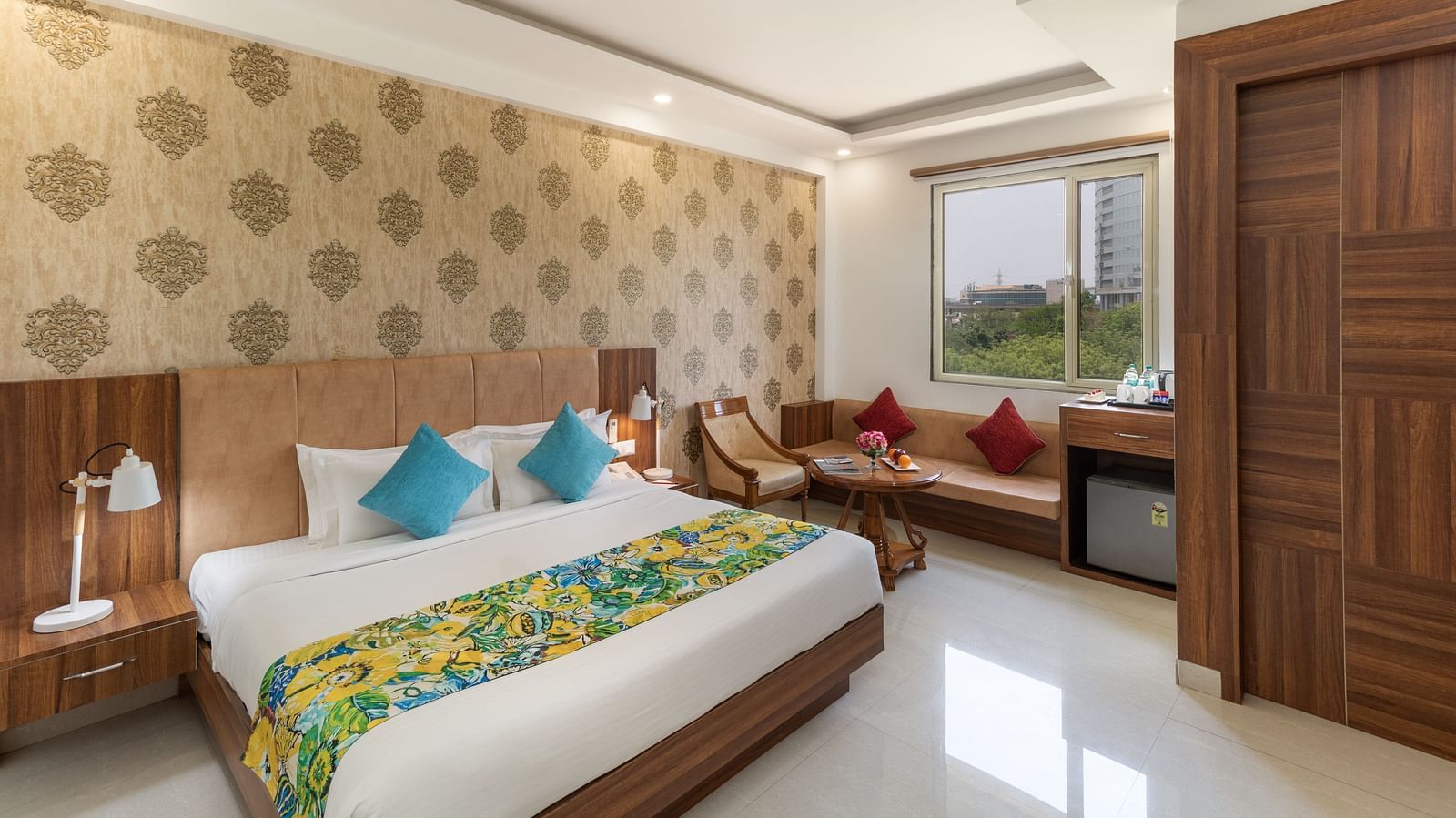 A spacious hotel room featuring a king size bed, comfortable seating, and modern amenities | Inde Hotel Cyber City 