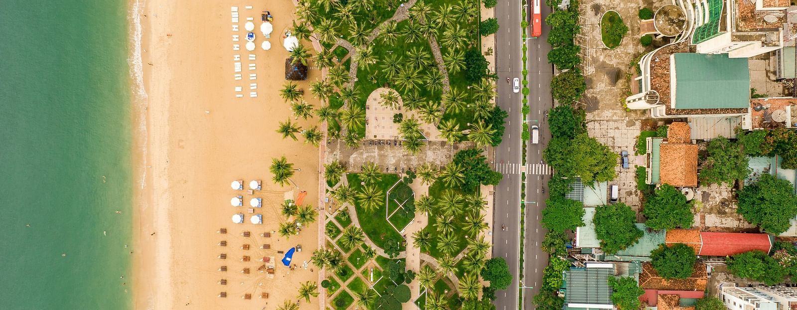 An aerial view of Nha Trang with the beach, sea, nature, road and buildings in view
