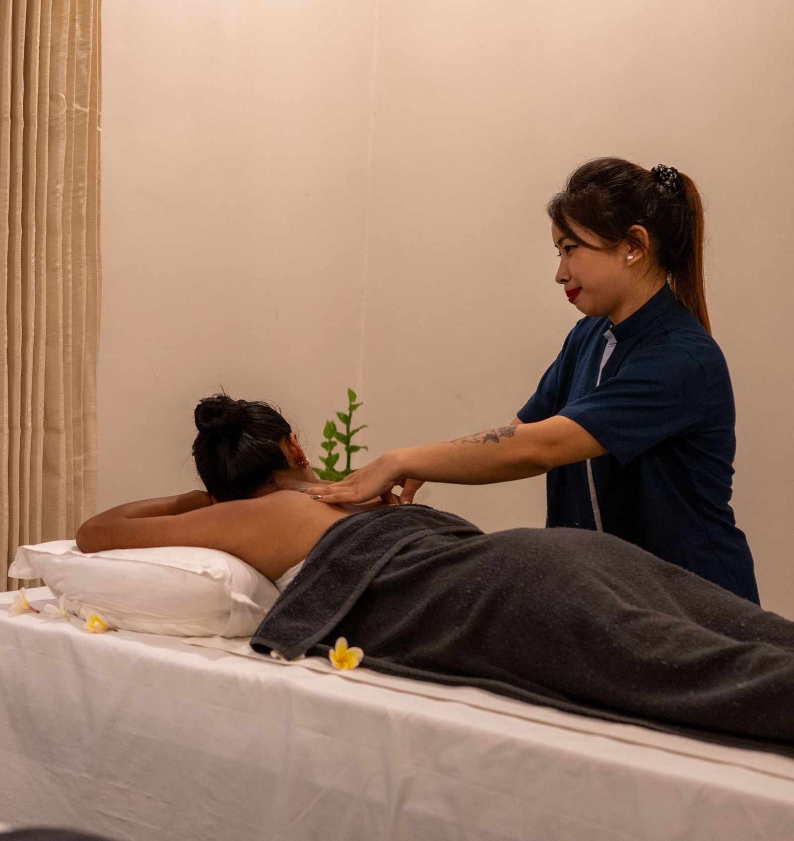 A masseuse providing a back massage - Utsav Camp