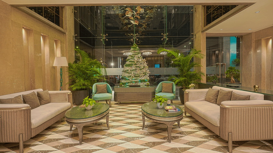 The hotel lobby with beige sofas, armchairs and a checkered floor-  BluSalzz