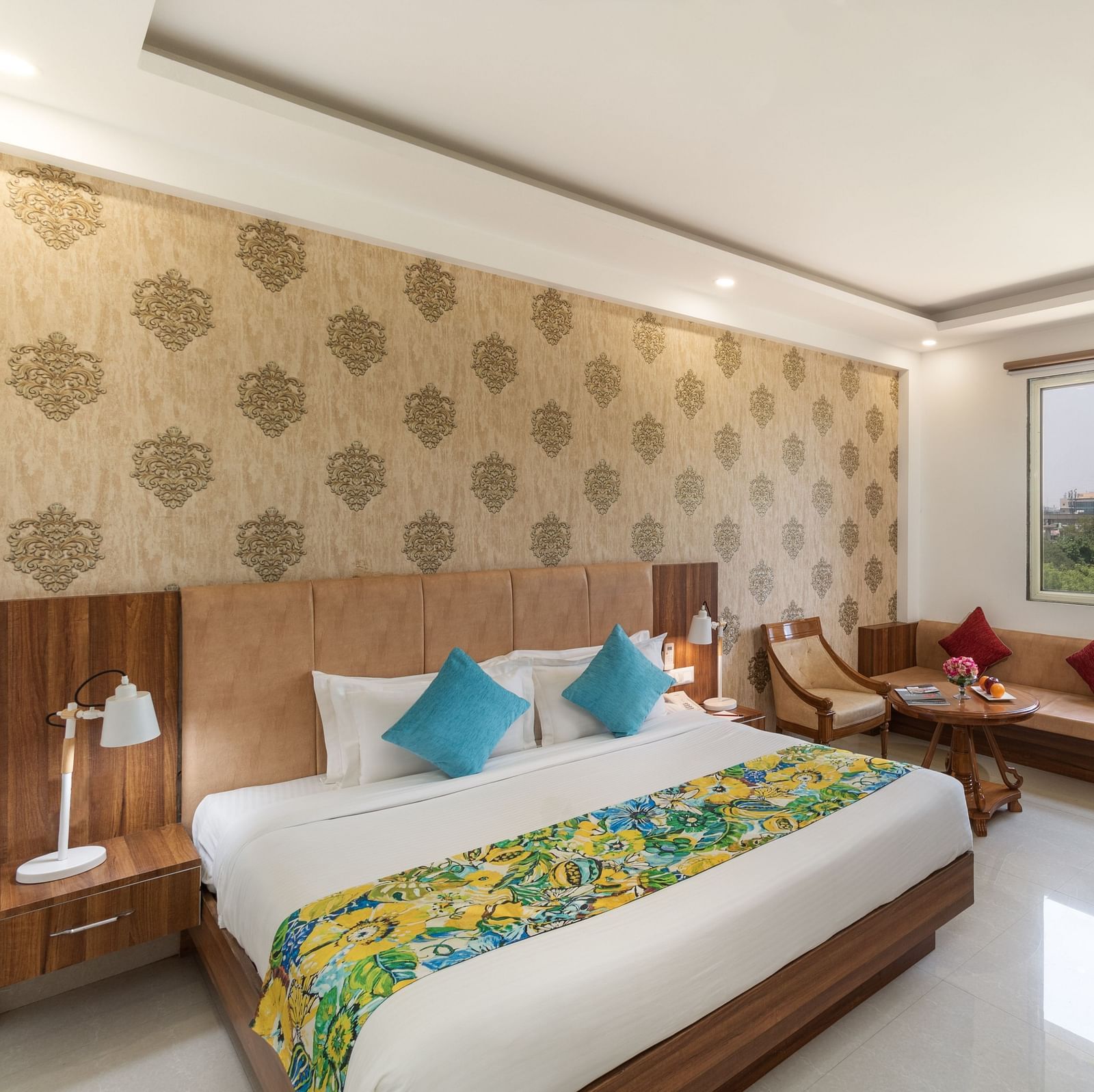 A spacious hotel room featuring a king size bed, comfortable seating, and modern amenities | Inde Hotel Cyber City 