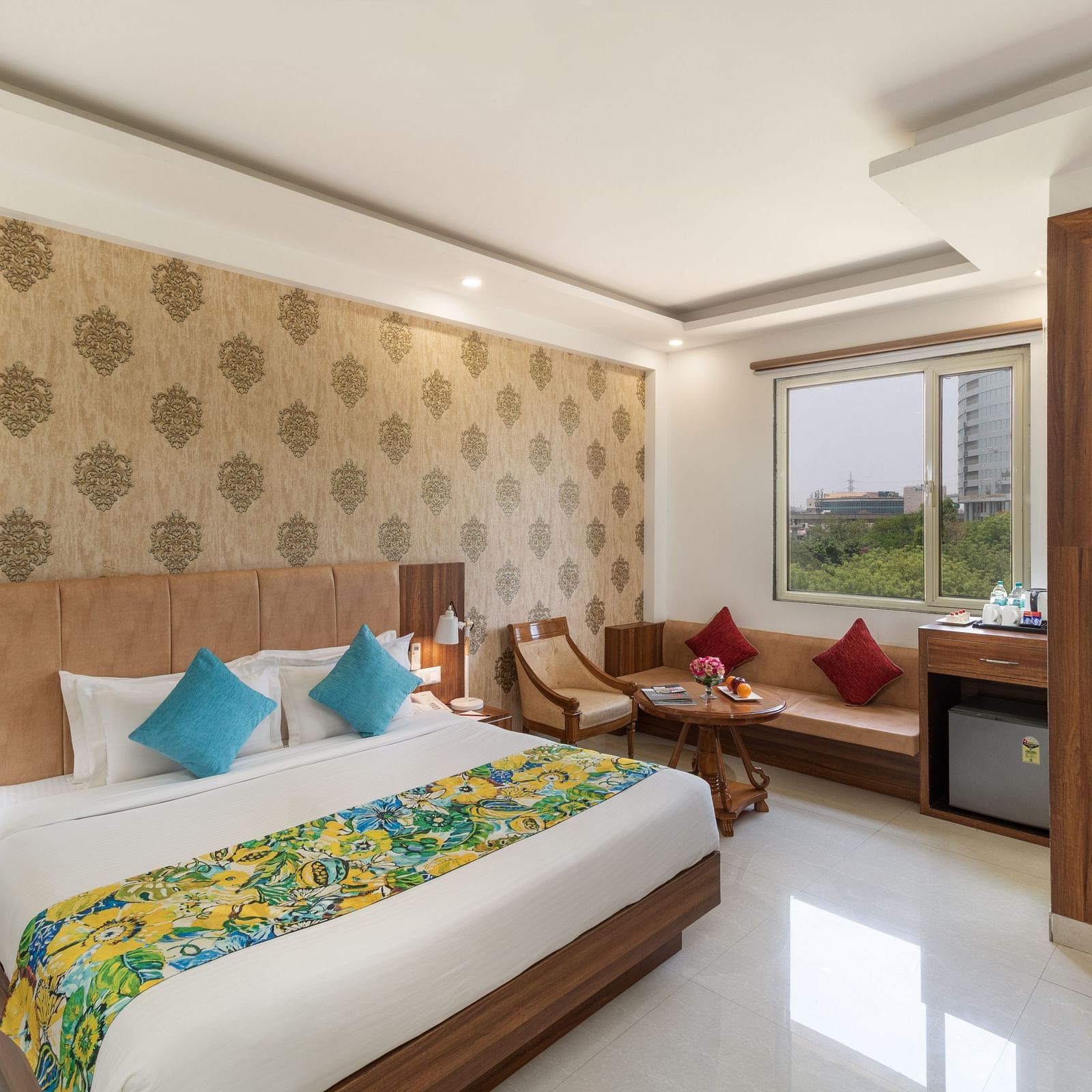 A spacious hotel room featuring a king size bed, comfortable seating, and modern amenities | Inde Hotel Cyber City 
