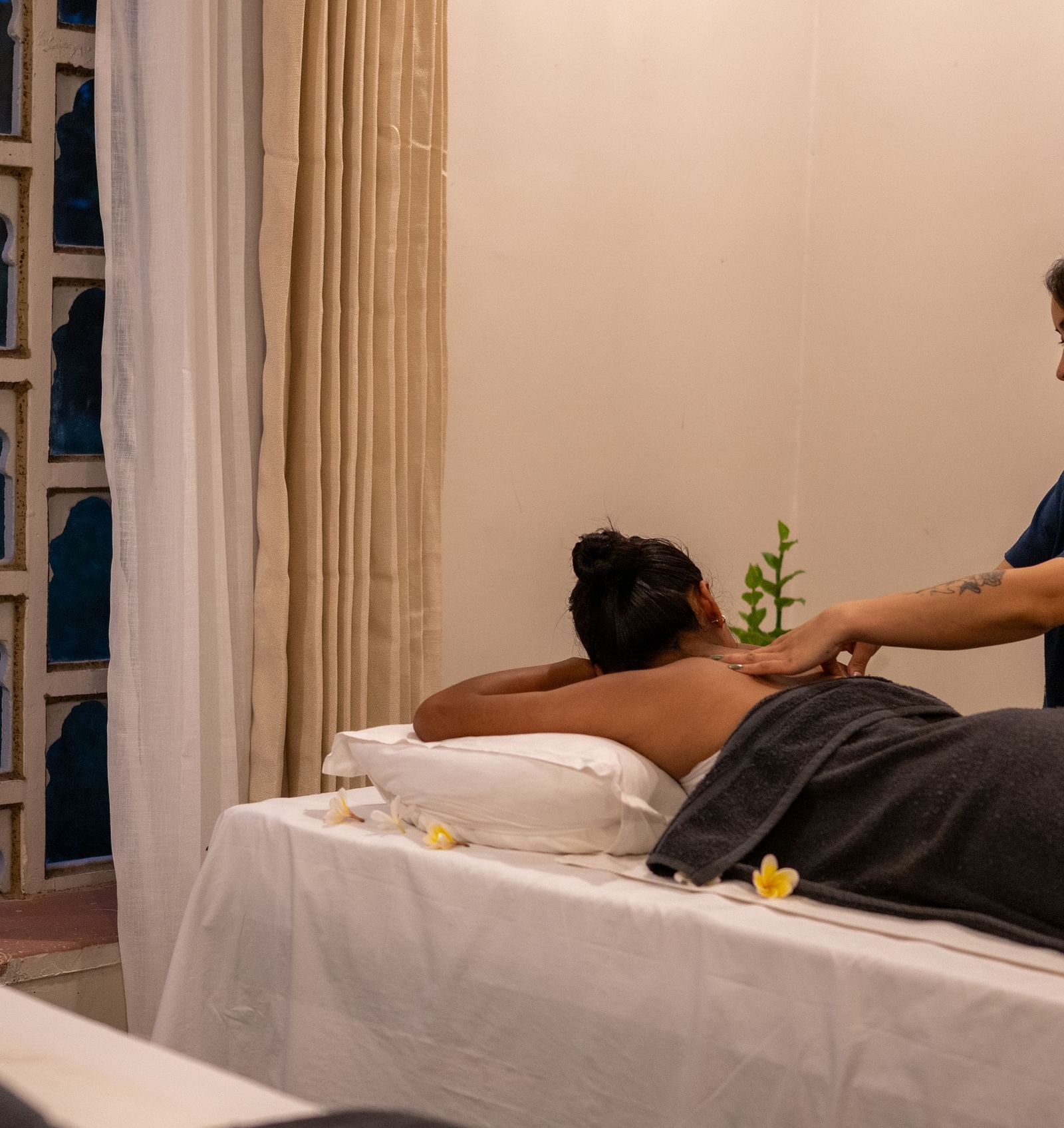 A masseuse providing a back massage - Utsav Camp