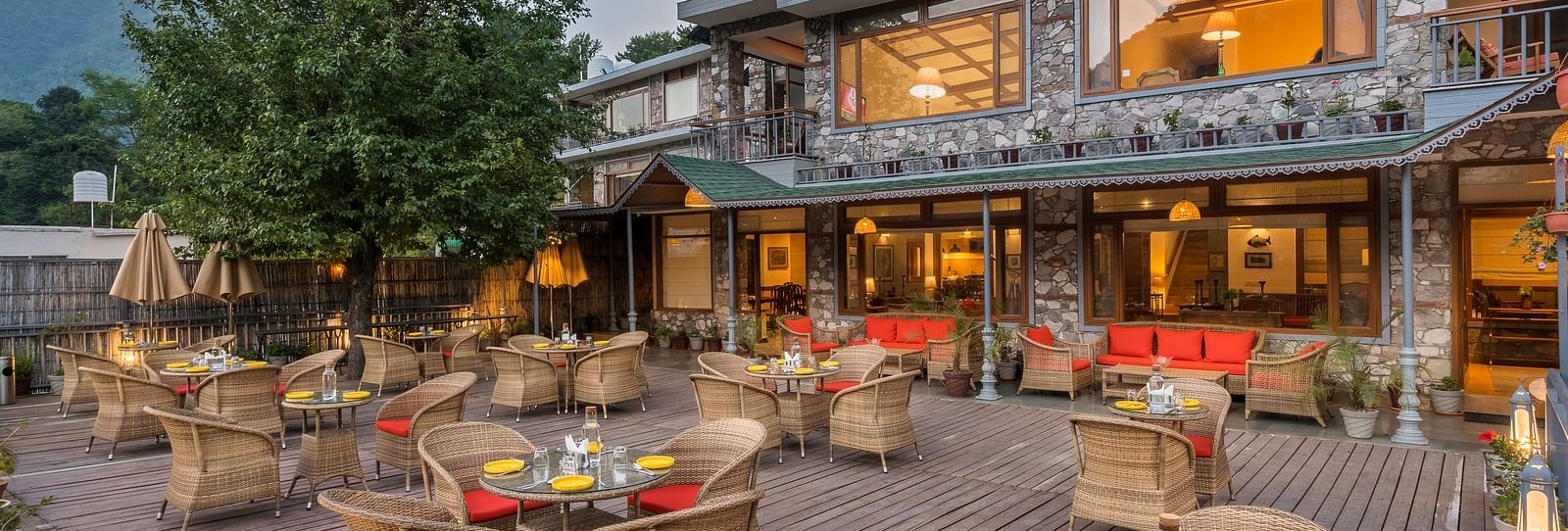 the exterior of the L ATTITUDE DECK  in the evening, with the dining arrangements made in the front- Leisure Hotels