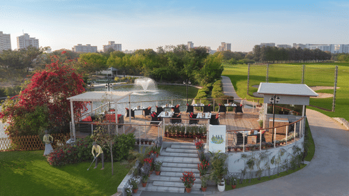 An overview of an outdoor space next to a waterbody - Karma Lakelands.