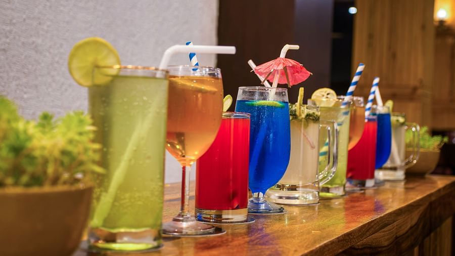  A vibrant display of colourful and refreshing drinks lined up on a polished bar counter, inviting guests to unwind and socialise - Digantaa Resort in Mukteshwar