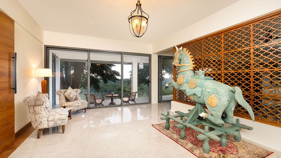 A modern living area with elegant furnishings, including a sculpture in the centre and large windows offering expansive views of the outdoors - Heavensa Villas and Suites by the Clarks, Galle