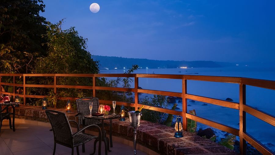 A warmly-lit gazebo seen during an evening overlooking the ocean - Highland Sarovar Portico, Sindhudurg