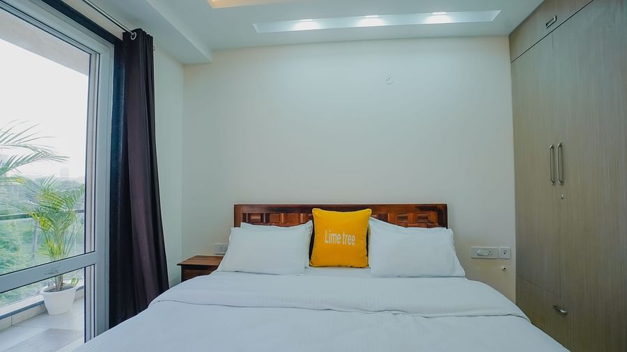 Lime Tree Hotel Golf Course Extension Road Gurgaon - Double with pillows and balcony door on the side