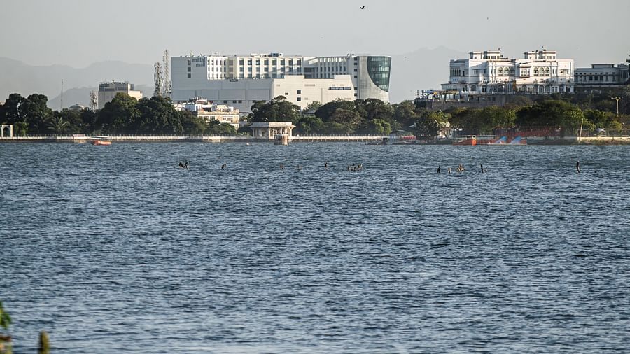 Distant lakeside view of Sarovar Premiere, Udaipur across the serene waters