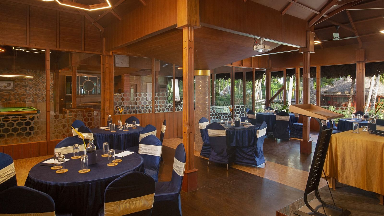 A well-set dining room with dark blue tablecloths and wooden chairs. The room is well-lit with contemporary lighting, offering a sophisticated dining environment - Coral Reef Resort & Spa, Havelock