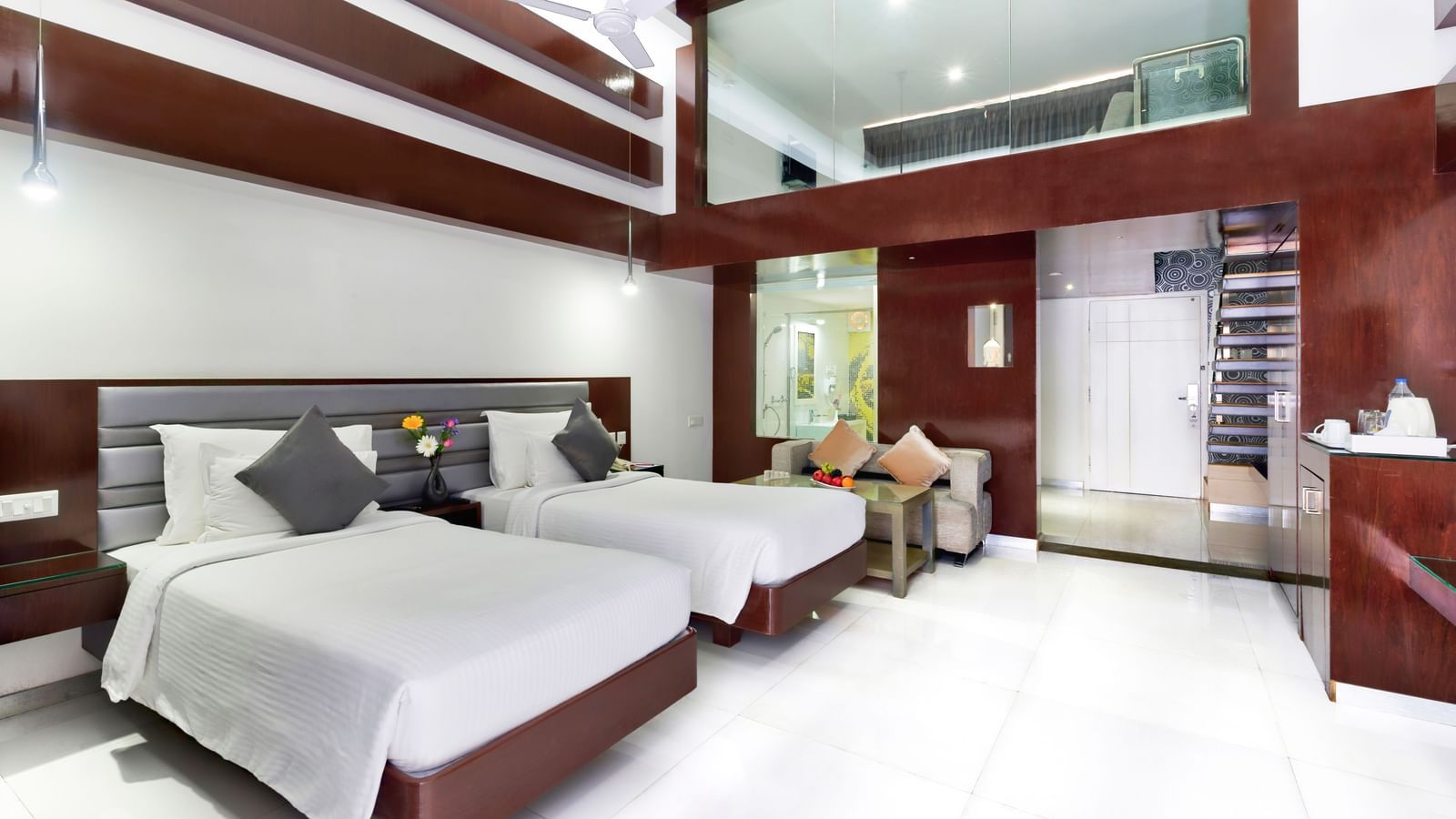 A clean hotel room featuring two beds with white linens, wooden accent walls, and a large window | Grande Duplex Twin | Grand Bay Resort and Spa
