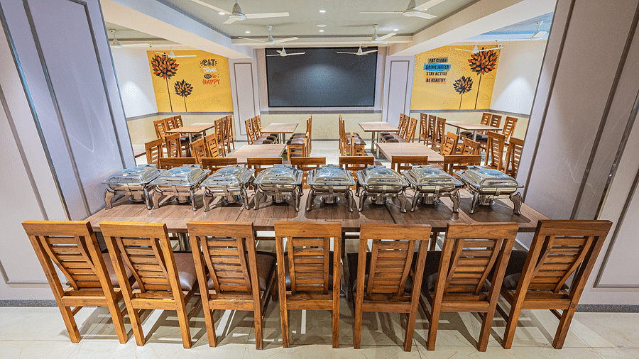 A banquet hall setup with a long table and chairs, ideal for events or conferences at Lotus Leaf Boutique Hotel.