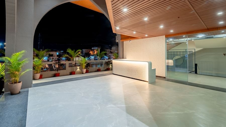 Lobby area of Pravasa Hotel with a front desk and ample lighting | Pravasa Hotel, Vijayapura