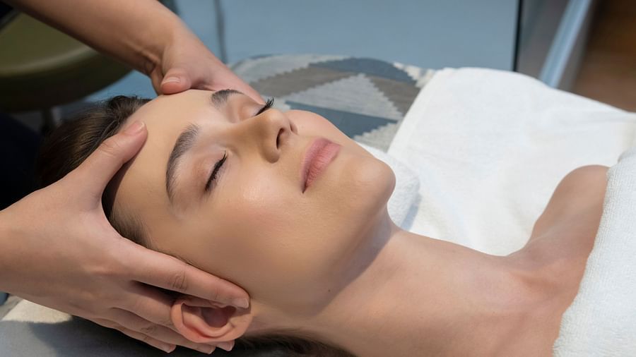 A woman enjoying a face massage treatment at Cinqtuair Spa in New Delhi