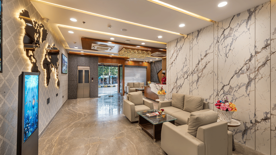 A polished Lords Hotel lobby featuring marble walls, plush seating, and warm lighting.