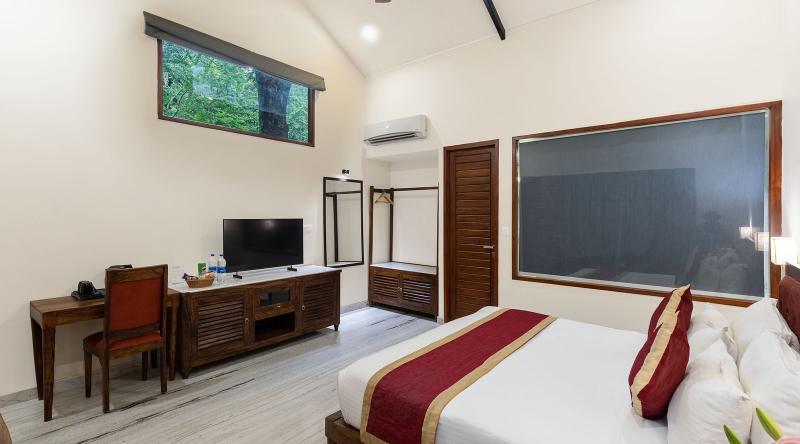 corner view image of the luxury bathtub villa featuring a king size bed and a television in front of it at the luxury bathtub villa