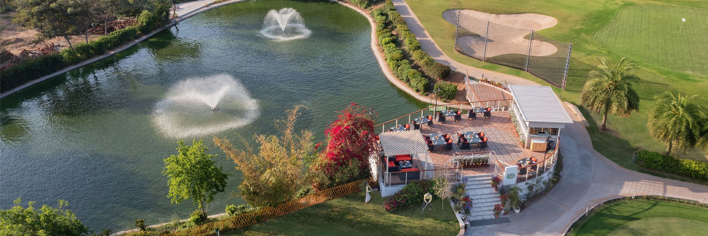 Overview of Lake 360 restaurant next to a lake at Karma Lakelands Gurgaon