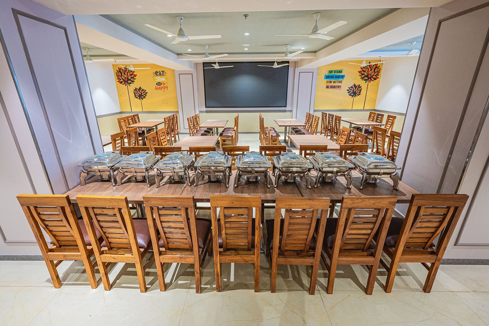 A banquet hall setup with a long table and chairs, ideal for events or conferences at Lotus Leaf Boutique Hotel.
